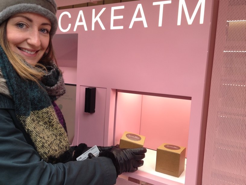 Sprinkles Cupcakes opens NYC's 1st cupcake atm.  Happy patron purchases a treat