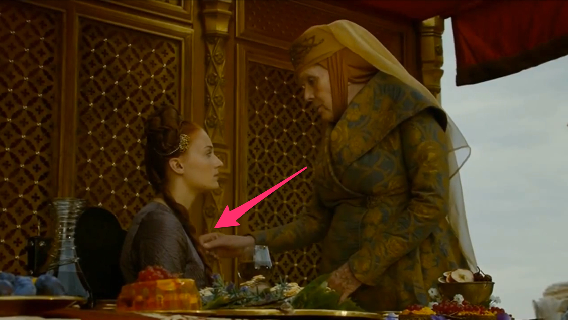 Olenna Tyrell can be seen fondling Sansa Stark necklace before she sits to eat at the wedding dinner